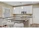 Bright kitchen featuring stone backsplash, stainless appliances, and a large center island at 3420 Lockport St, Las Vegas, NV 89129
