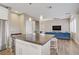 Open floor plan with a kitchen island, stainless appliances, and view into the cozy living room at 3420 Lockport St, Las Vegas, NV 89129