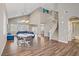 Open-concept living area with high ceilings, wood floors, and stylish modern furnishings at 3420 Lockport St, Las Vegas, NV 89129