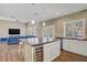 Open concept featuring stone accents, a modern island with a wine fridge, and a cozy living space at 3420 Lockport St, Las Vegas, NV 89129