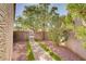 The desert garden and the pathway lead to the gate that accesses the rest of the property at 3420 Lockport St, Las Vegas, NV 89129