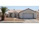 Charming single-story home with stucco exterior, desert landscaping, and attached two-car garage at 3524 Silver Lantern Dr, North Las Vegas, NV 89032