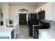 Modern kitchen with white cabinets, stainless steel appliances, and quartz countertops at 3524 Silver Lantern Dr, North Las Vegas, NV 89032