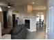 Open-concept living room with hardwood floors, a fireplace, and a view into the kitchen at 3524 Silver Lantern Dr, North Las Vegas, NV 89032