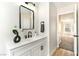 This bathroom features a black mirror, black faucet, wood floors, and a door leading to the bedroom at 416 Greenbrook St, Las Vegas, NV 89110