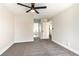 This spacious bedroom has neutral colored walls and carpet and two entry ways to other parts of the house at 416 Greenbrook St, Las Vegas, NV 89110