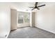 This bedroom features neutral carpet, two windows allowing for lots of natural light, and a modern ceiling fan at 416 Greenbrook St, Las Vegas, NV 89110