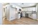 A recently updated modern kitchen featuring white cabinetry, stainless steel appliances, and wood floors at 416 Greenbrook St, Las Vegas, NV 89110