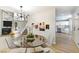 Open-concept living room features a fireplace, dining area, and pass-through to an all-white kitchen at 416 Greenbrook St, Las Vegas, NV 89110