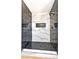 This modern shower features gray and white marble tiling with dark honeycomb floor tiling at 416 Greenbrook St, Las Vegas, NV 89110