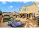 Backyard features a covered patio, lounge chairs, grassy area, hot tub, and mature landscaping at 421 Raindance Dr, Henderson, NV 89014