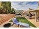 Inviting backyard features a hot tub, artificial grass, and comfortable lounge seating, perfect for outdoor relaxation at 421 Raindance Dr, Henderson, NV 89014