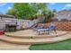 Backyard featuring lounge chairs, a grill, a block wall, and desert landscaping at 421 Raindance Dr, Henderson, NV 89014