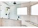 This updated bathroom features a large glass shower with black hardware and marble-look tile at 421 Raindance Dr, Henderson, NV 89014