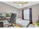 Bedroom with light wood floors, gray walls, ceiling fan, and a built-in desk area perfect for an office at 421 Raindance Dr, Henderson, NV 89014