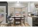 Bright dining area with a dark wood table set and a window overlooking backyard at 421 Raindance Dr, Henderson, NV 89014