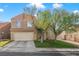Two-story home featuring a two-car garage, neutral colored exterior, and a well-maintained lawn at 421 Raindance Dr, Henderson, NV 89014