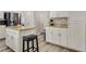 Bright kitchen features white cabinets, granite countertops, stainless steel appliances, and breakfast bar with seating at 421 Raindance Dr, Henderson, NV 89014