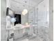 Modern bathroom with marble floors, tub, glass enclosed shower, and dual sinks at 4381 W Flamingo Rd # 1003, Las Vegas, NV 89103