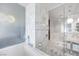 Modern bathroom features marble tiling, a stand-alone shower, and soaking tub at 4381 W Flamingo Rd # 1003, Las Vegas, NV 89103