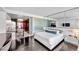 Comfortable bedroom with full kitchen, mirrored wall and dark floors at 4381 W Flamingo Rd # 1003, Las Vegas, NV 89103