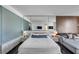 Contemporary bedroom with bed, side tables, mirrored headboard, and a couch at 4381 W Flamingo Rd # 1003, Las Vegas, NV 89103