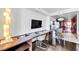 Bedroom with desk, tv and kitchenette with bar stool seating at 4381 W Flamingo Rd # 1003, Las Vegas, NV 89103