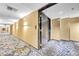 Long hallway with patterned carpet and hotel room doors at 4381 W Flamingo Rd # 1003, Las Vegas, NV 89103