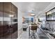Modern kitchenette featuring sleek cabinets, stainless steel appliances, and adjacent dining and living spaces at 4381 W Flamingo Rd # 1003, Las Vegas, NV 89103