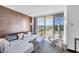 Modern living room with a comfortable sofa, glass coffee table, and large window with city views at 4381 W Flamingo Rd # 1003, Las Vegas, NV 89103