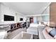 Open-concept living area with modern furnishings, sleek entertainment center, and comfortable sleeping space at 4381 W Flamingo Rd # 1003, Las Vegas, NV 89103