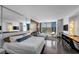 Spacious living space with a comfortable bed, sleek sofa, and large windows offering stunning city views at 4381 W Flamingo Rd # 1003, Las Vegas, NV 89103