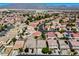 Aerial shot shows homes in a planned community with mountain views, landscaping and nearby shopping at 448 Bright Moon Ave, North Las Vegas, NV 89084