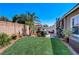 Well-maintained backyard with lush lawn, patio area, and privacy fence at 448 Bright Moon Ave, North Las Vegas, NV 89084