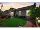 Private backyard featuring lush lawn, mature trees, and outdoor patio area at 448 Bright Moon Ave, North Las Vegas, NV 89084