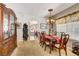 Formal dining area with a classic table, elegant lighting, and seamless flow to the living space at 448 Bright Moon Ave, North Las Vegas, NV 89084