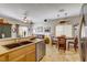 Open-concept kitchen flowing into dining and living areas with stainless steel appliances and breakfast bar at 448 Bright Moon Ave, North Las Vegas, NV 89084