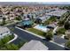 Community aerial view showcases pool, playground, landscaping, and mountain views at 4566 Mansart Ct # 1104, North Las Vegas, NV 89031