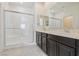 Bathroom featuring double sinks, vanity with storage, and glass-enclosed shower at 4566 Mansart Ct # 1104, North Las Vegas, NV 89031
