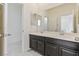 Bathroom showcasing double vanity sinks, toilet, with an open doorway, designed for comfort at 4566 Mansart Ct # 1104, North Las Vegas, NV 89031