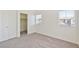 Carpeted bedroom featuring a closet and two windows, offering ample natural light at 4566 Mansart Ct # 1104, North Las Vegas, NV 89031