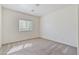 A clean, carpeted bedroom with a window, ensuring a bright and airy atmosphere at 4566 Mansart Ct # 1104, North Las Vegas, NV 89031