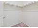 Walk-in closet with double rods, carpet flooring, and white walls, a great storage space at 4566 Mansart Ct # 1104, North Las Vegas, NV 89031