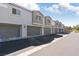 A row of townhomes featuring attached garages, neutral paint, and well-maintained landscaping at 4566 Mansart Ct # 1104, North Las Vegas, NV 89031