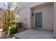 Inviting front entrance with a well-manicured shrub, walkway, and a stylish blue door at 4566 Mansart Ct # 1104, North Las Vegas, NV 89031