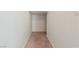 Narrow hallway with neutral carpet and white walls leading to another room at 4566 Mansart Ct # 1104, North Las Vegas, NV 89031