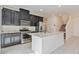 Spacious kitchen boasts granite counters, stainless appliances, and ample dark wood cabinetry at 4566 Mansart Ct # 1104, North Las Vegas, NV 89031