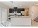 Open-concept kitchen featuring stainless steel appliances and granite countertops and dark cabinets at 4566 Mansart Ct # 1104, North Las Vegas, NV 89031