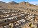 Areal view of a Primary-planned community in the desert with single-Gathering homes, landscaping, and mountain views at 461 Cascade Heights Ave, Las Vegas, NV 89138