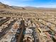 Areal view of a Primary-planned community in the desert with single-Gathering homes, landscaping, and mountain views at 461 Cascade Heights Ave, Las Vegas, NV 89138